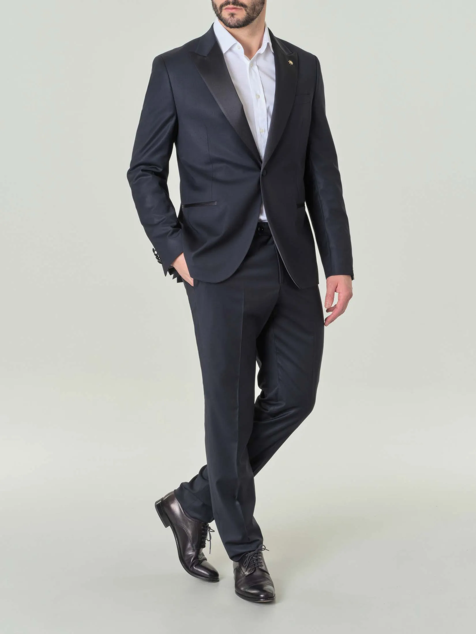 Abito blu in tela di lana stretch con revers a lancia
